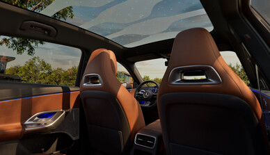Innenraum des Mercedes-Benz GLC mit Panorama-Glasdach, braunen Ledersitzen und modernem Ambientelicht in Blau. | © Mercedes-Benz AG
